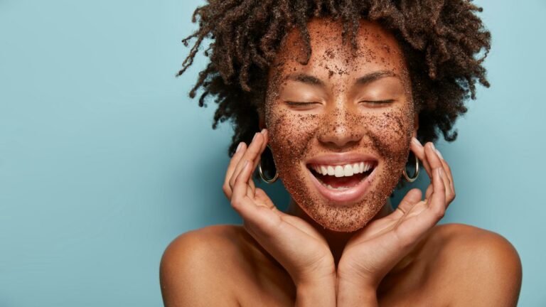 Ragazza sorridente con occhi chiusi con caffè sul viso